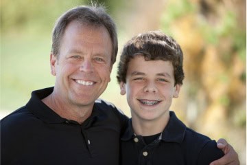 Father With Son Wearing Traditional Metal Braces